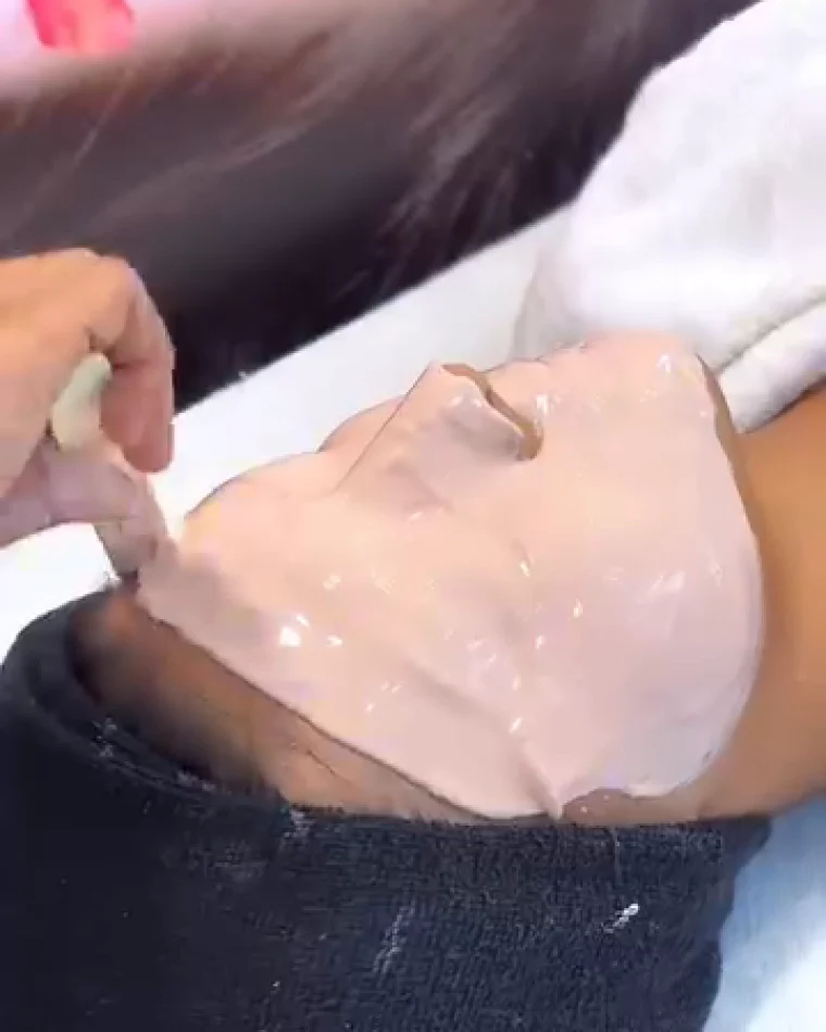 A pale cooling pack spread across the face and left to settle.
