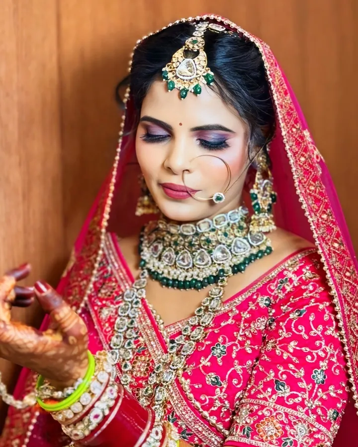 A two-slide carousel of the same bride against a plain warm wood panel wall.