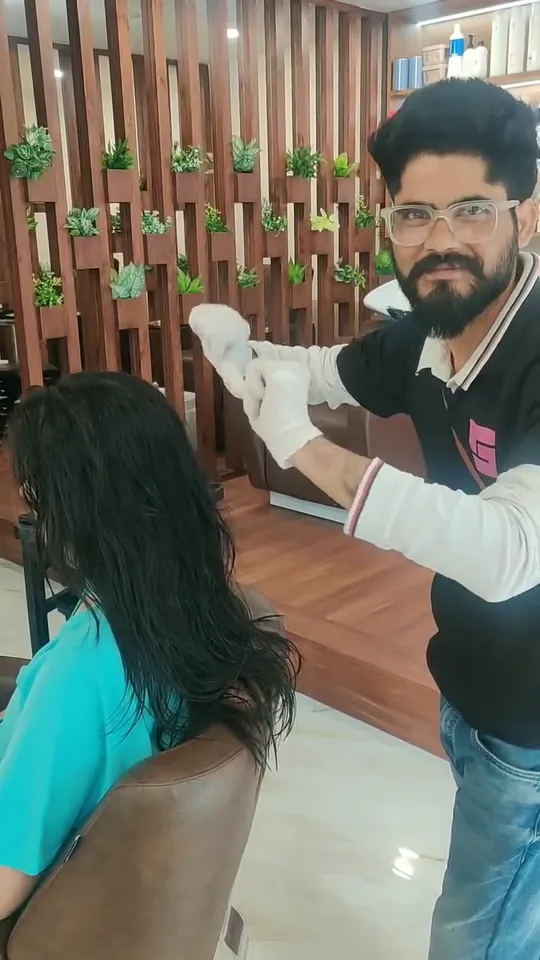 A stylist mixes treatment in a bowl, works it through a client's hair, then irons it straight and shows the finished length.