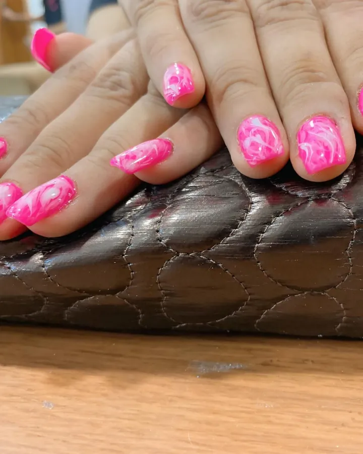 Two-image carousel of finished nails, both read.
