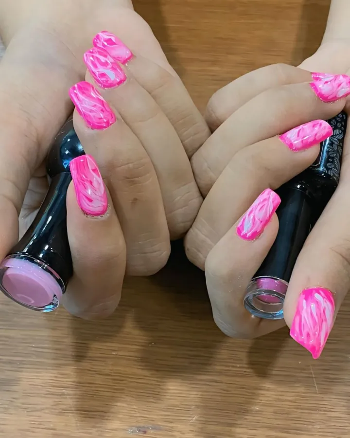Two-image carousel of finished nails, both read.