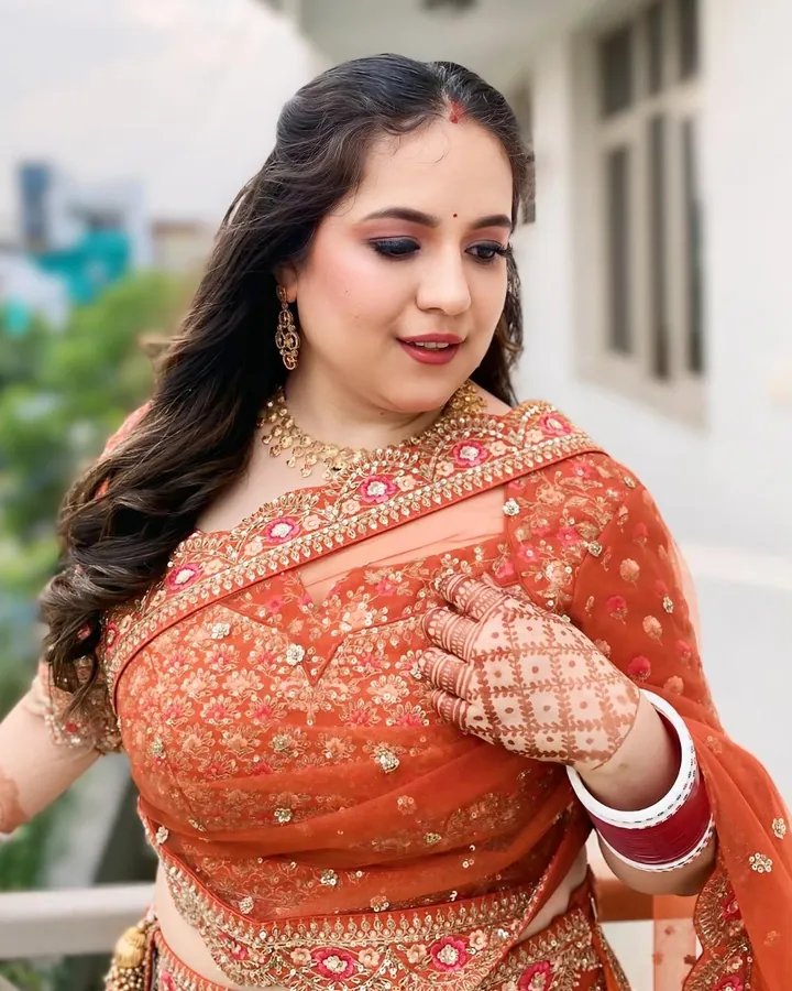 Carousel of four images (three read) of one woman on an open terrace with a white railing, greenery and city rooftops behind her.