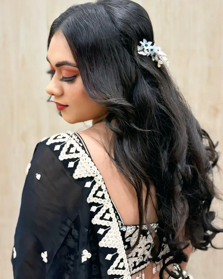 Three-image carousel of one client in a black lehenga with white thread-and-mirror embroidery and a sheer black dupatta.